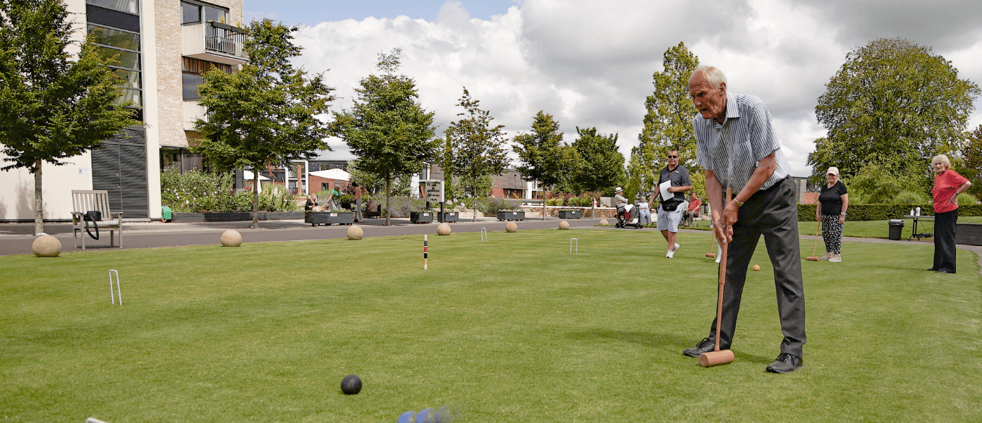 Elderly men playing golf